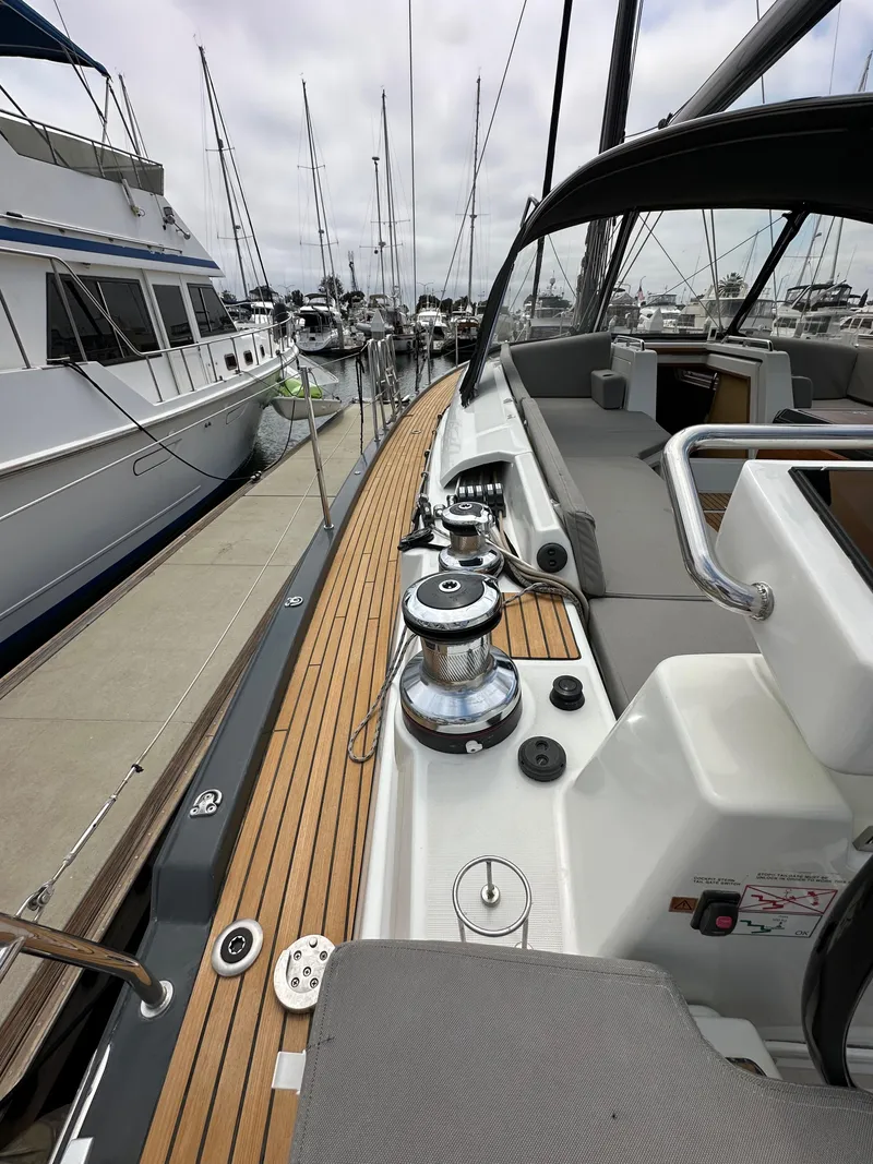 Slide: The Image of 2018 Jeanneau 54 yacht deck with winches, docked at marina. - 32