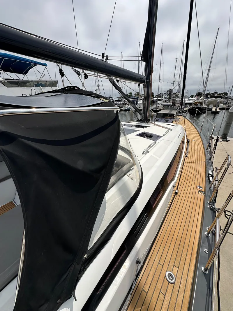 Slide: The Image of 2018 Jeanneau 54 sailboat with teak deck, docked at marina. - 42