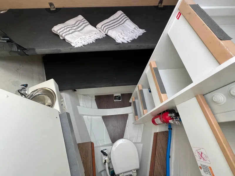 Slide: The Image of Interior of 2018 Jeanneau 54 yacht showing compact bathroom and storage area. - 48
