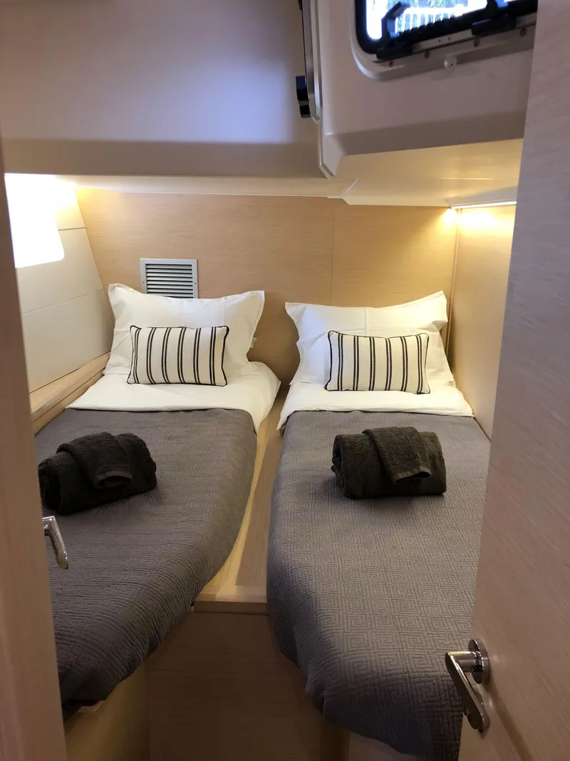 Slide: The Image of Cozy twin cabin in 2018 Jeanneau 54 yacht with modern decor and soft lighting. - 81