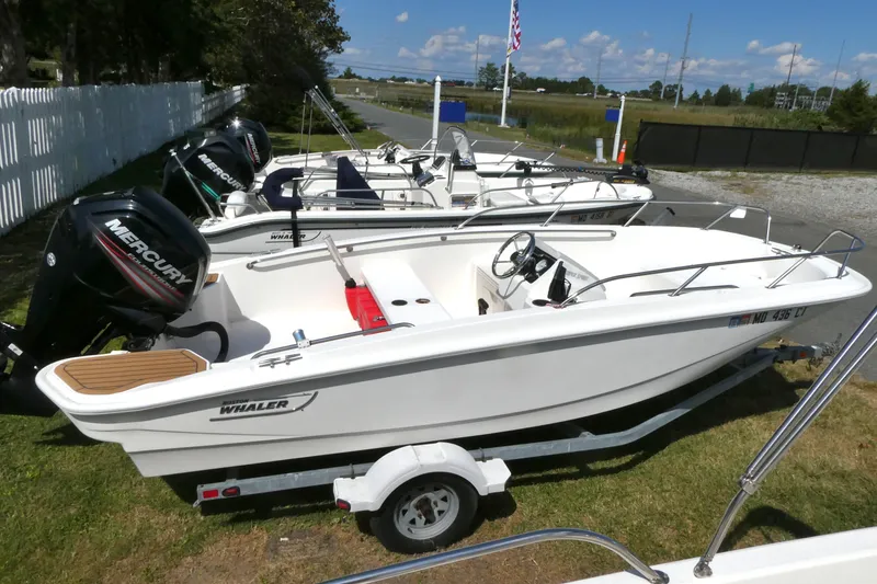 Slide: The Image of 2019 Boston Whaler 160 Super Sport boat on trailer, featuring Mercury outboard engine. - 2