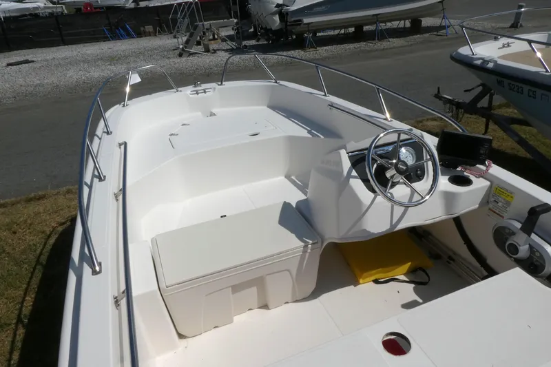 Slide: The Image of 2019 Boston Whaler 160 Super Sport boat interior with steering wheel and seating. - 6