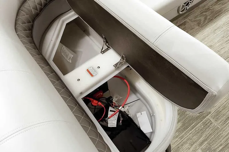 Slide: The Image of 2024 Ranger Reata 223C boat seat storage compartment with wiring and battery. - 10