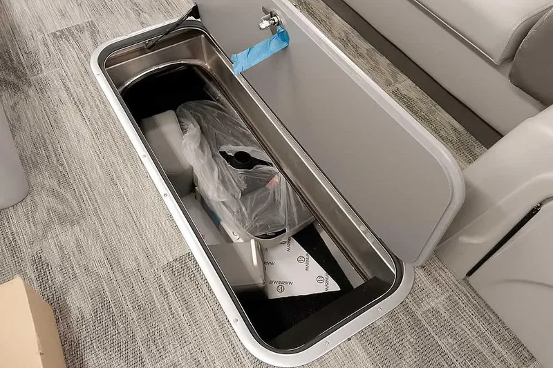 Slide: The Image of 2024 Ranger Reata 223C storage compartment with open lid, revealing interior contents. - 18