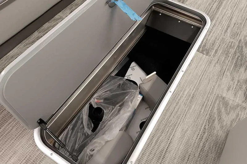 Slide: The Image of Open storage compartment in 2024 Ranger Reata 223C boat, showing interior contents. - 19