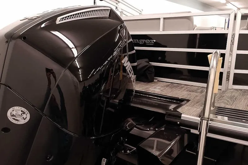 Slide: The Image of 2024 Ranger Reata 223C boat with powerful black outboard motor and sleek design. - 2