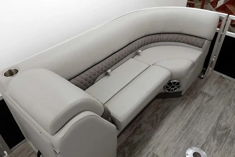 Slide: The Image of 2024 Ranger Reata 223C boat interior with plush seating and cup holder. - 21