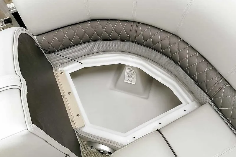 Slide: The Image of 2024 Ranger Reata 223C boat seat storage compartment with diamond-stitched upholstery. - 24