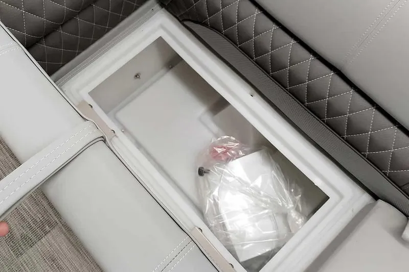 Slide: The Image of 2024 Ranger Reata 223C boat seat storage compartment with quilted upholstery. - 26