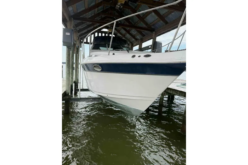 Slide: The Image of 2002 Donzi Z 32 EXPRESS boat docked under a covered structure. - 11