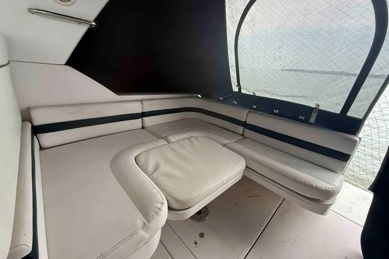 Slide: The Image of 2002 Donzi Z 32 EXPRESS boat interior with white cushioned seating and black accents. - 8