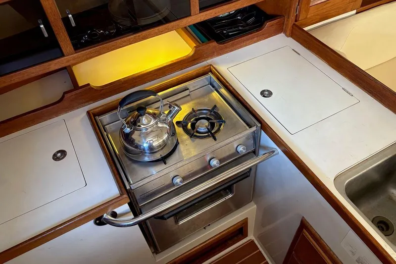 Slide: The Image of Compact kitchen in 1992 Catalina Sloop with stove, kettle, and sink. - 7