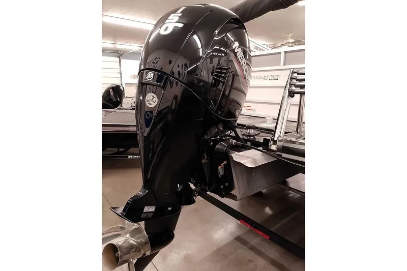 Slide: The Image of 2025 Ranger Reata 220C with Mercury 150 outboard motor in showroom. - 2