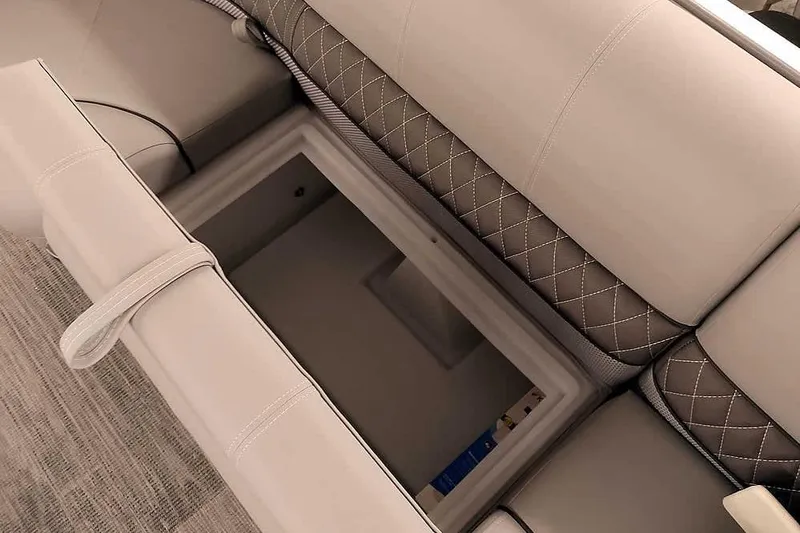 Slide: The Image of 2025 Ranger Reata 220C boat seat storage compartment, featuring quilted upholstery design. - 21