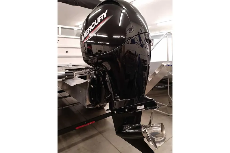 Slide: The Image of 2025 Ranger Reata 220C with Mercury outboard motor in a showroom setting. - 3