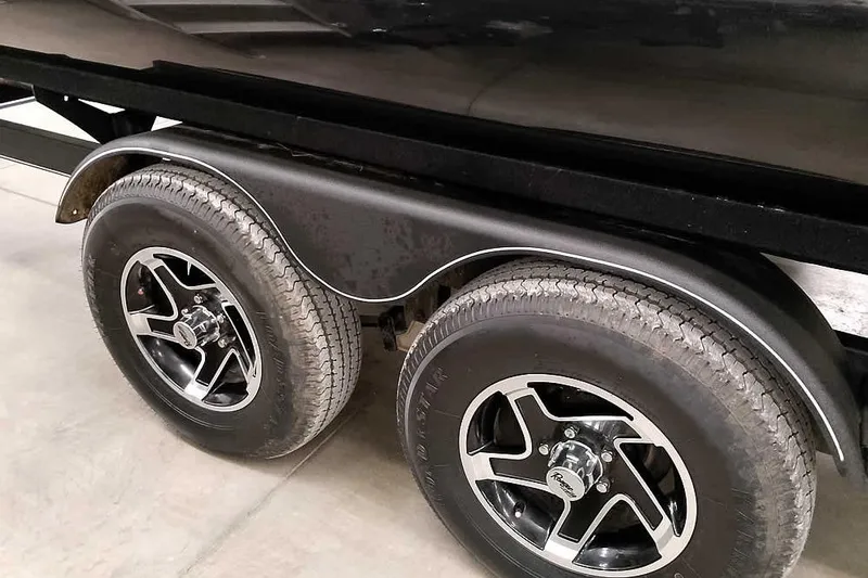 Slide: The Image of 2025 Ranger Reata 220C trailer wheels with black and silver rims. - 6