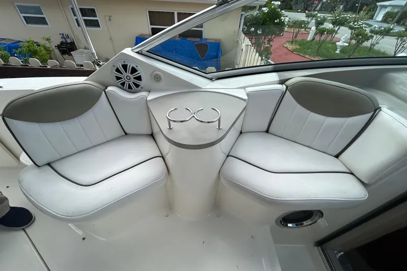Slide: The Image of 2007 Sea Ray 240 Sundancer boat interior with white seating and cup holders. - 18