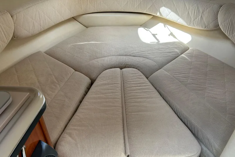 Slide: The Image of 2007 Sea Ray 240 Sundancer cabin interior with beige upholstery and cushioned seating. - 26