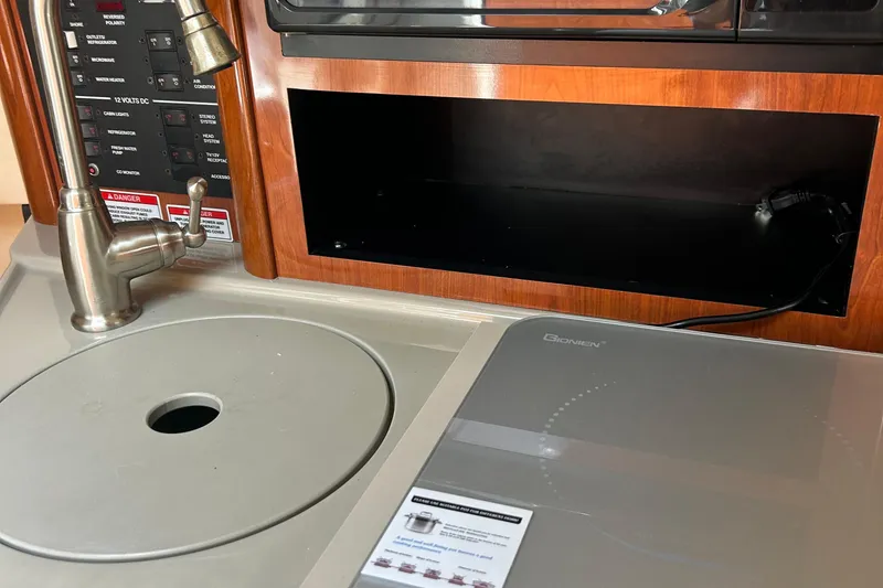 Slide: The Image of Interior of 2007 Sea Ray 240 Sundancer boat with sink and control panel. - 28