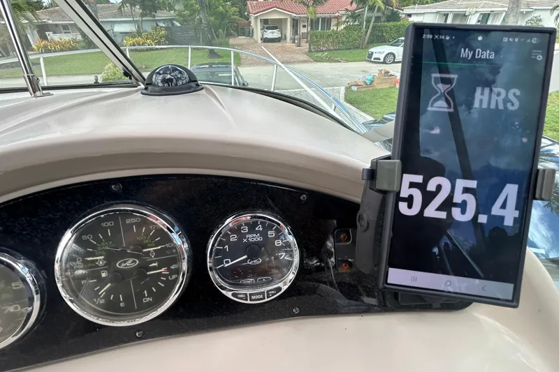 Slide: The Image of Dashboard of a 2007 Sea Ray 240 Sundancer boat with gauges and digital display. - 38