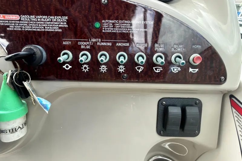 Slide: The Image of Control panel of a 2007 Sea Ray 240 Sundancer boat with labeled switches and keys. - 39