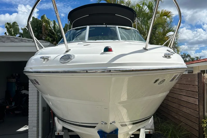 Slide: The Image of 2007 Sea Ray 240 Sundancer boat on trailer, parked near tropical plants. - 5