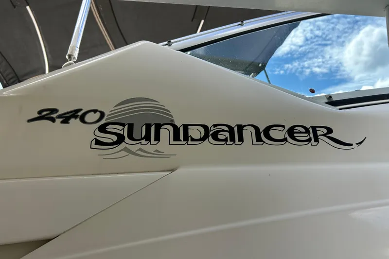 Slide: The Image of 2007 Sea Ray 240 Sundancer boat logo with sky background. - 6