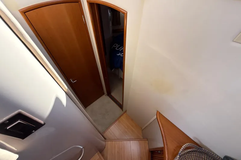 Slide: The Image of Interior view of 2005 Carver 36 Sedan, featuring wooden stairs and door. - 13
