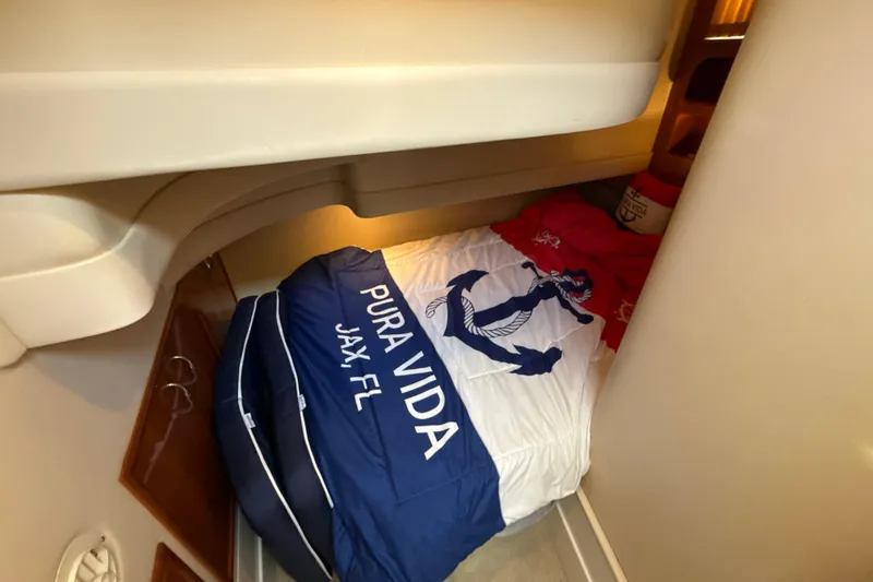 Slide: The Image of Cozy cabin bed in 2005 Carver 36 Sedan with nautical-themed bedding. - 16