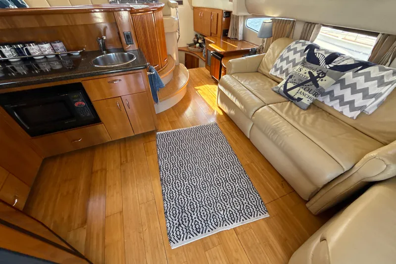 Slide: The Image of Interior of 2005 Carver 36 Sedan with kitchen, sofa, and nautical decor. - 21