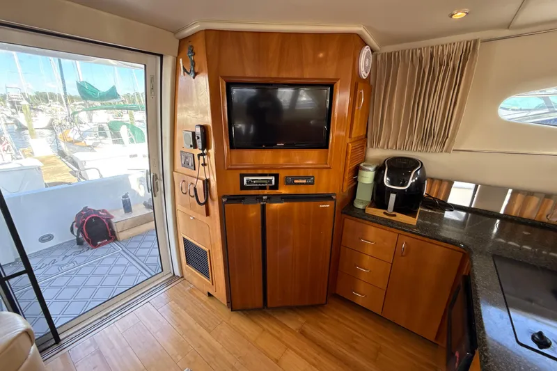 Slide: The Image of Interior of 2005 Carver 36 Sedan yacht with kitchenette and entertainment area. - 22