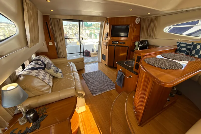 Slide: The Image of Luxurious interior of a 2005 Carver 36 Sedan yacht with elegant wood finishes. - 24
