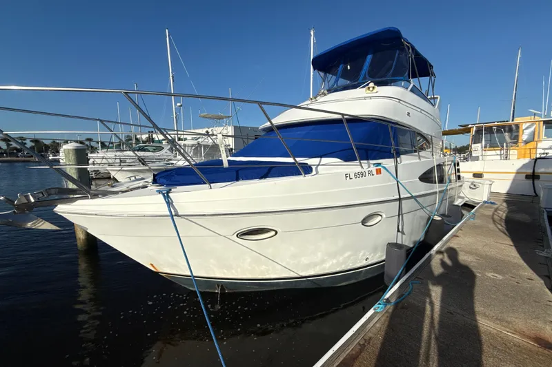 Slide: The Image of 2005 Carver 36 Sedan yacht docked at marina under clear blue sky. - 25