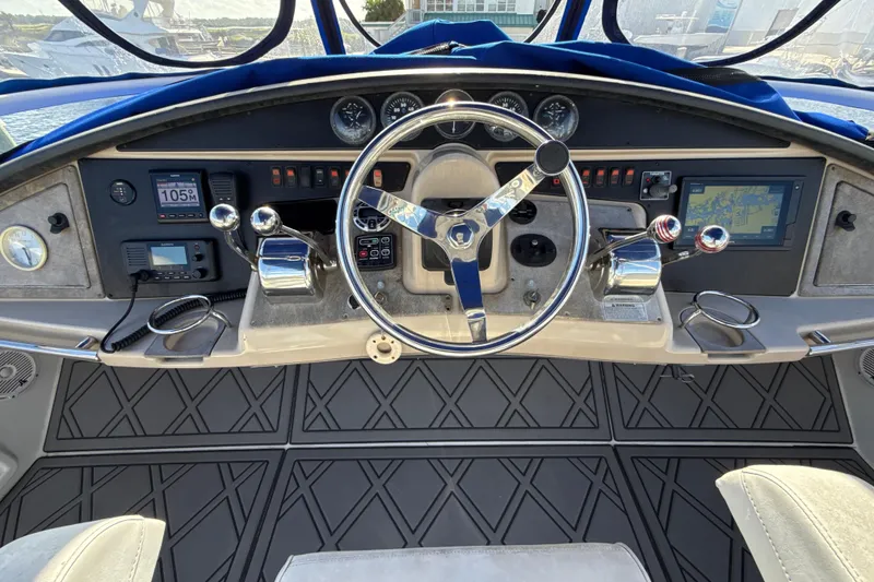 Slide: The Image of 2005 Carver 36 Sedan helm with steering wheel, navigation controls, and dashboard instruments. - 31