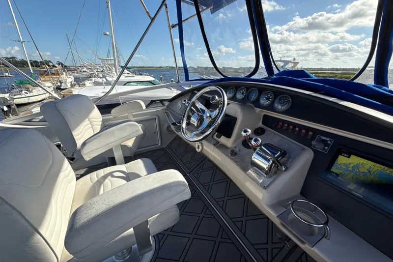 Slide: The Image of Interior view of 2005 Carver 36 Sedan yacht cockpit with steering wheel and navigation controls. - 32