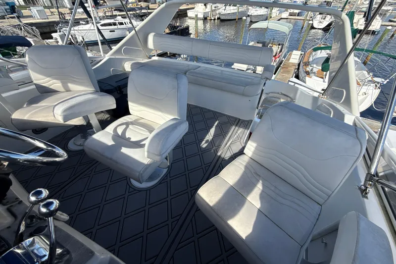 Slide: The Image of 2005 Carver 36 Sedan interior with white seating, docked at marina. - 36