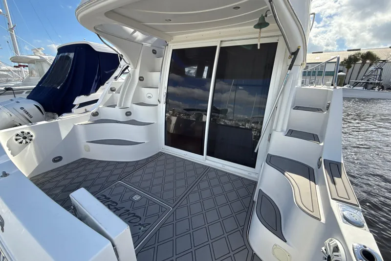 Slide: The Image of 2005 Carver 36 Sedan yacht deck with sliding glass doors and water view. - 38