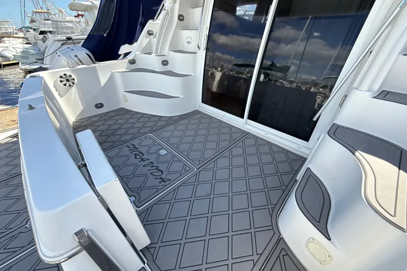 Slide: The Image of 2005 Carver 36 Sedan yacht deck with patterned flooring and sliding glass doors. - 45