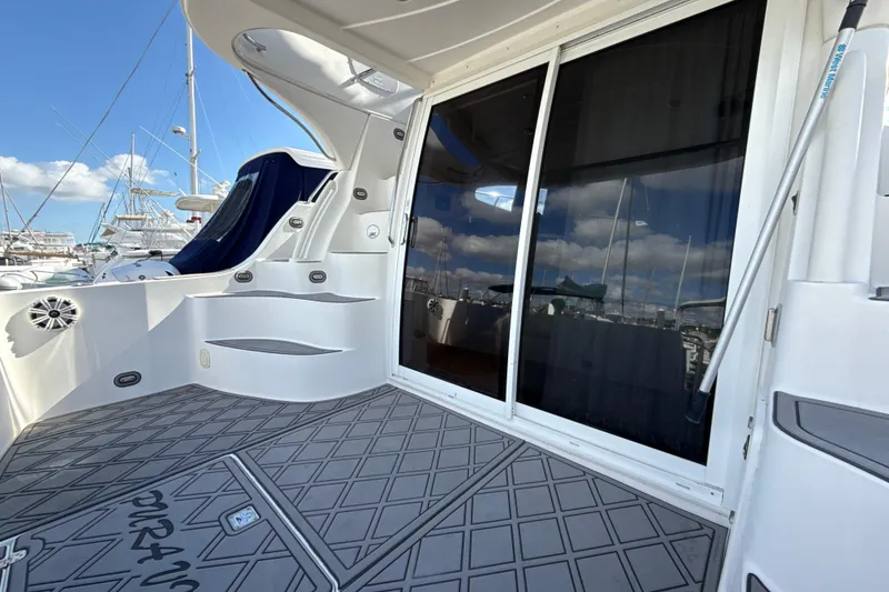 Slide: The Image of 2005 Carver 36 Sedan yacht deck with sliding glass doors and marina view. - 46