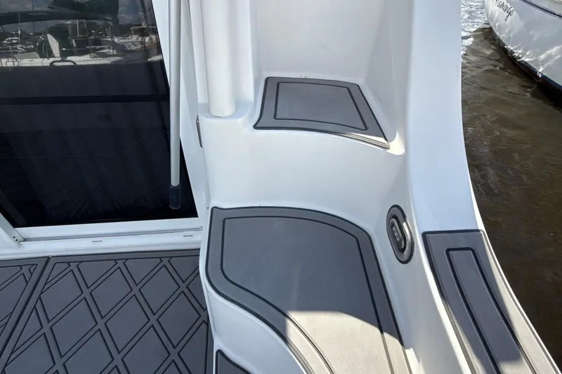 Slide: The Image of 2005 Carver 36 Sedan boat deck with gray non-slip flooring and water view. - 50
