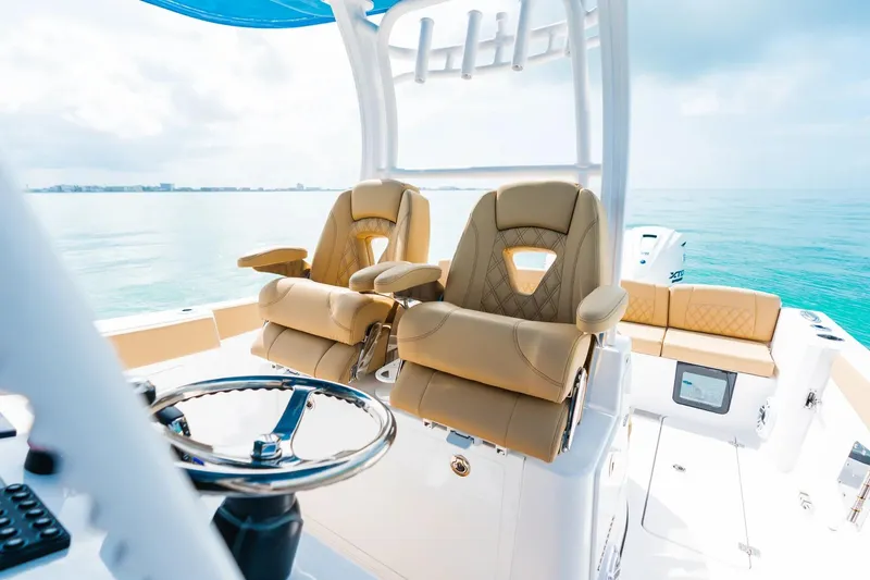 Slide: The Image of 2026 Sportsman Heritage 321 Center Console boat with luxurious seating and ocean view. - 6