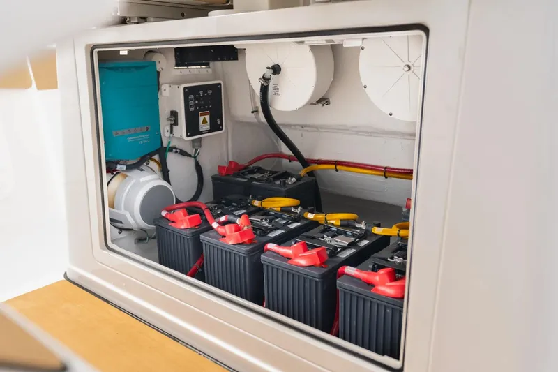 Slide: The Image of 2026 Sportsman Heritage 321 Center Console battery compartment with multiple batteries and wiring. - 11