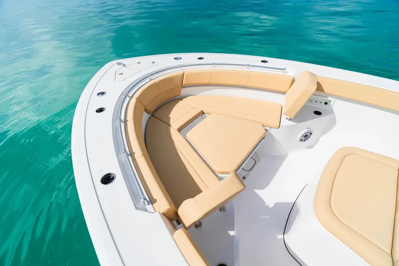 Slide: The Image of 2026 Sportsman Heritage 321 Center Console boat with tan seating on turquoise water. - 3