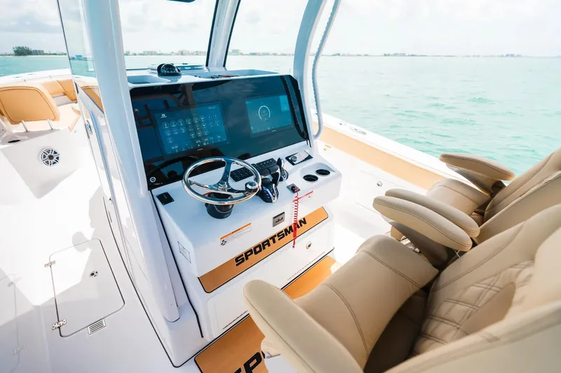 Slide: The Image of 2026 Sportsman Heritage 321 Center Console boat interior with modern dashboard and seating. - 5