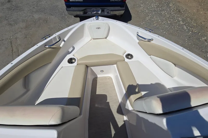 Slide: The Image of 2015 Regal 1900 Bowrider boat interior with beige seating and cup holders. - 10