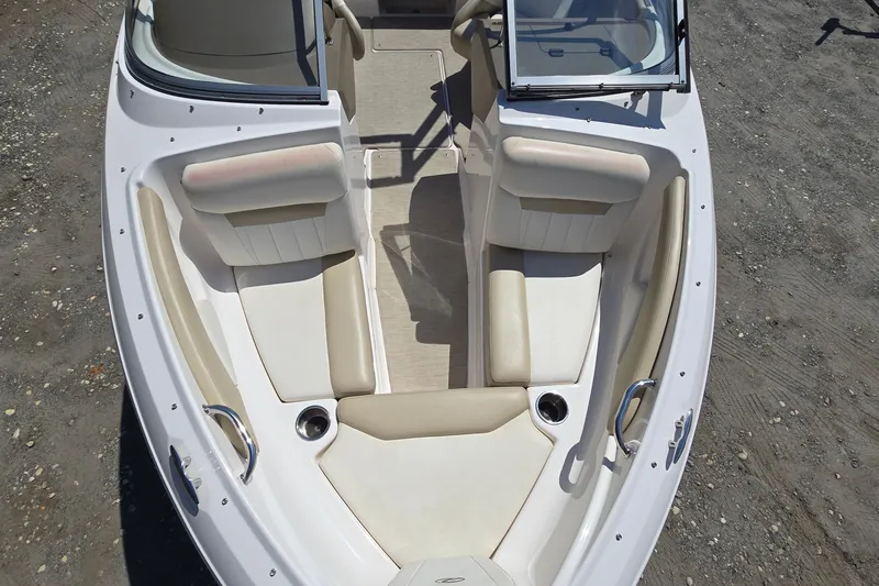 Slide: The Image of 2015 Regal 1900 Bowrider boat interior with beige seating and cup holders. - 11