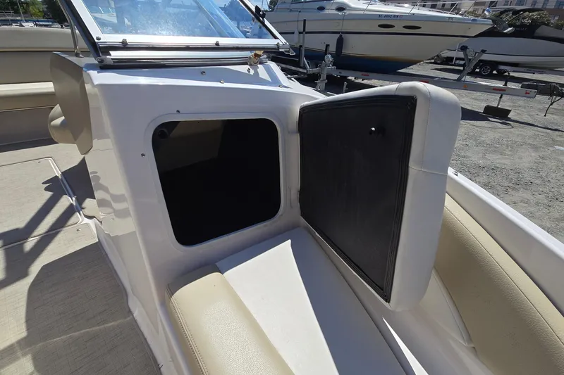 Slide: The Image of 2015 Regal 1900 Bowrider boat interior with open storage compartment and seating. - 13