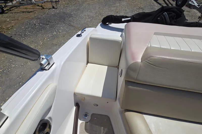 Slide: The Image of 2015 Regal 1900 Bowrider boat interior with beige seating and white accents. - 15