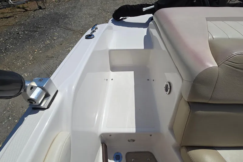 Slide: The Image of 2015 Regal 1900 Bowrider interior, featuring beige seating and white deck. - 16