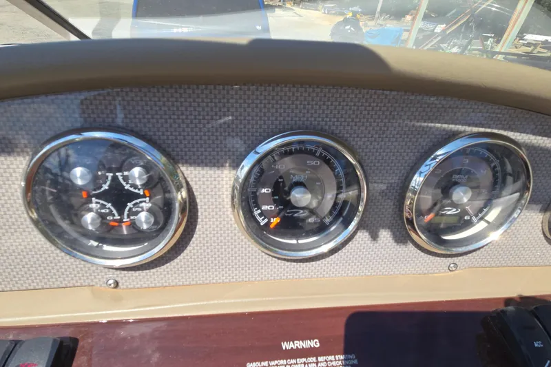 Slide: The Image of Dashboard of a 2015 Regal 1900 Bowrider boat with gauges and controls. - 23